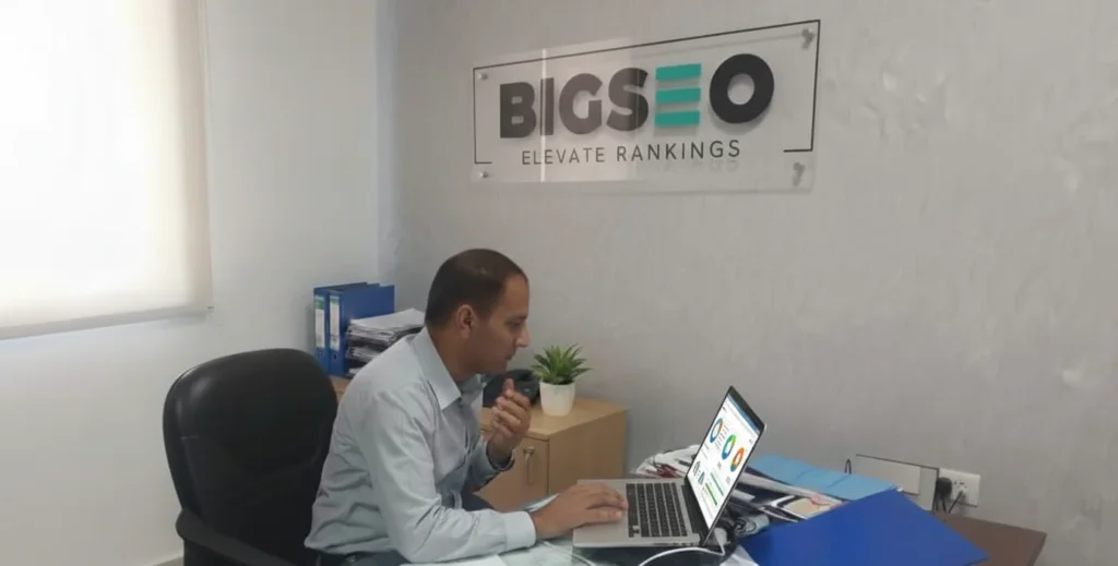SEO professional working on a laptop in a modern digital marketing office analyzing search ranking data